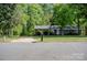 Classic brick home with mature trees, a long driveway, and a traditional mailbox at 438 Starcrest Cir # C, Rock Hill, SC 29730