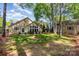 Spacious backyard with mature trees, well-maintained lawn, and storage shed offers privacy at 4467 Woodlark Ln, Charlotte, NC 28211
