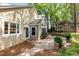 Back of house showing the yard with stone patio, small garden, and storage shed at 4467 Woodlark Ln, Charlotte, NC 28211