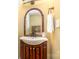 Bathroom with white sink, wooden vanity with mirror and small white hand towel at 4467 Woodlark Ln, Charlotte, NC 28211