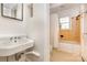 Bathroom featuring classic tile, a pedestal sink, and a shower with a window at 4467 Woodlark Ln, Charlotte, NC 28211