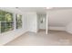 Bright bedroom with neutral carpet, natural light from multiple windows, and ample space for relaxation at 4467 Woodlark Ln, Charlotte, NC 28211