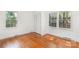 Bright bedroom featuring hardwood floors, natural light from the windows, and closet space at 4467 Woodlark Ln, Charlotte, NC 28211