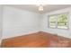 Inviting bedroom featuring hardwood floors and a window, creating a comfortable and well-lit space at 4467 Woodlark Ln, Charlotte, NC 28211