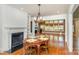 Open dining room with hardwood floors, fireplace, built-in shelving and ample natural light at 4467 Woodlark Ln, Charlotte, NC 28211