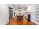 Elegant dining room with hardwood floors, modern chandelier, fireplace and built-in shelving at 4467 Woodlark Ln, Charlotte, NC 28211