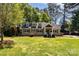 Well-maintained front exterior of this single-Gathering home with mature trees and landscaped front lawn at 4467 Woodlark Ln, Charlotte, NC 28211