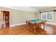 Well-lit game room featuring a classic billiard table and gleaming hardwood flooring at 4467 Woodlark Ln, Charlotte, NC 28211