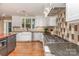 Modern kitchen with stainless steel appliances, white cabinets, and large windows at 4467 Woodlark Ln, Charlotte, NC 28211
