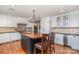 Spacious kitchen featuring a butcher block island, custom cabinetry, and hardwood floors at 4467 Woodlark Ln, Charlotte, NC 28211