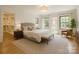 Serene main bedroom with views, neutral tones, and an adjacent bathroom and walk-in closet at 4467 Woodlark Ln, Charlotte, NC 28211