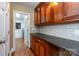 Butler's pantry area with cabinets, granite countertops, and view into laundry room at 4467 Woodlark Ln, Charlotte, NC 28211