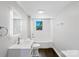 Bathroom showcasing new vanity, toilet, framed mirror, and shower/tub combo at 502 Hyde St, Kannapolis, NC 28083