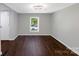 Cozy bedroom with neutral paint, wood floors, and ample natural light through a large window at 502 Hyde St, Kannapolis, NC 28083