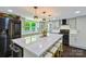 This updated kitchen boasts stainless steel appliances, a large island, and a sleek black range hood at 502 Hyde St, Kannapolis, NC 28083