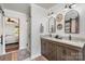 Double vanity bathroom featuring modern lighting, framed mirrors, granite counters, and a sliding glass door shower at 5047 Victory Trl, Gastonia, NC 28056