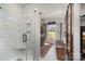 Elegant bathroom showcasing a glass shower, decorative tiling, modern fixtures, and wood storage cabinet at 5047 Victory Trl, Gastonia, NC 28056