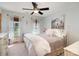 Cozy bedroom with a ceiling fan, two windows for natural light and an inviting bed with soft linens at 5047 Victory Trl, Gastonia, NC 28056