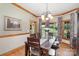 Elegant dining room featuring wood floors, wainscoting, and a picturesque view of the outdoors at 5047 Victory Trl, Gastonia, NC 28056