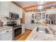 Bright kitchen with stainless steel appliances, granite countertops, and wooden ceiling beams at 5047 Victory Trl, Gastonia, NC 28056