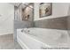 Elegant bathroom featuring a soaking tub with gray tile accents and a modern fixture at 510 Black Bear St # 145P, China Grove, NC 28023