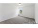 Neutral carpeted bedroom with light walls and a window at 510 Black Bear St # 145P, China Grove, NC 28023