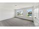 Bright bedroom featuring two windows and neutral carpeting at 510 Black Bear St # 145P, China Grove, NC 28023