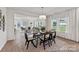 Bright and airy dining area with large windows and a stylish table, open to the living room at 510 Black Bear St # 145P, China Grove, NC 28023