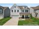 Charming two-story home with white siding, a welcoming front porch, and well-manicured lawn at 510 Black Bear St # 145P, China Grove, NC 28023