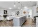 Open kitchen flowing into the living room and dining area, featuring a large island at 510 Black Bear St # 145P, China Grove, NC 28023