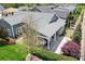 Expansive aerial view showcases the home's large patio, verdant landscaping, custom pond, and tranquil putting green at 5103 Looking Glass Trl, Denver, NC 28037
