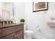 Cozy bathroom features a dark wood vanity and an ample sink area and modern fixtures at 5103 Looking Glass Trl, Denver, NC 28037