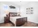 A bedroom featuring a queen bed, hardwood floors, neutral walls, and natural light at 5103 Looking Glass Trl, Denver, NC 28037