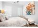 A calm bedroom with hardwood floors, neutral walls, a floral painting, and bright windows at 5103 Looking Glass Trl, Denver, NC 28037