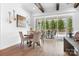 Bright dining room with wood floors, beamed ceiling, and sliding doors to the patio at 5103 Looking Glass Trl, Denver, NC 28037