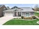 Inviting home featuring a well-manicured lawn, a two-car garage, and stone and siding details at 5103 Looking Glass Trl, Denver, NC 28037