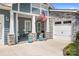 Inviting front porch with comfortable seating, flower pots, and stylish stone support columns at 5103 Looking Glass Trl, Denver, NC 28037