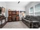 Comfortable home office with a leather sofa and a built-in dark wood desk and shelving at 5103 Looking Glass Trl, Denver, NC 28037