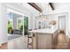 Bright open kitchen with island, bar seating, and sliding doors to the outdoor patio at 5103 Looking Glass Trl, Denver, NC 28037