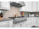 Modern kitchen features stainless steel stove with granite counters and white cabinets at 5103 Looking Glass Trl, Denver, NC 28037