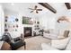 Cozy living room with fireplace, built-in shelving, beamed ceiling, and comfortable seating at 5103 Looking Glass Trl, Denver, NC 28037