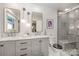 Modern bathroom with double sink vanity, gray cabinets and a tiled shower at 5218 Addison Dr, Charlotte, NC 28211