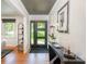 Stylish entryway with modern door, sleek console table, and hardwood floors at 5218 Addison Dr, Charlotte, NC 28211