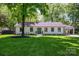 Charming, renovated single-story home with lush front lawn and mature trees at 5218 Addison Dr, Charlotte, NC 28211