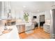 Bright kitchen with white cabinetry, stainless steel appliances, and hardwood floors at 5218 Addison Dr, Charlotte, NC 28211