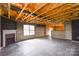 Basement showing an unfinished ceiling, fireplace, and partial wall at 5219 Biederbeck Dr, Charlotte, NC 28212
