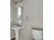 Bathroom with pedestal sink, toilet, and mirror at 5219 Biederbeck Dr, Charlotte, NC 28212