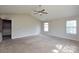 Spacious carpeted main bedroom features a vaulted ceiling, ceiling fan, and natural light from multiple windows at 5219 Biederbeck Dr, Charlotte, NC 28212