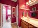 Bathroom view with pink walls, cabinets, and an open door to the toilet at 650 Raphael Pl, Charlotte, NC 28205