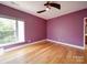 Bright bedroom features hardwood floors, a ceiling fan, and a large window at 650 Raphael Pl, Charlotte, NC 28205